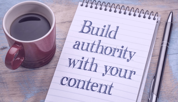 photo of mug, tablet, pen - build authority with your content